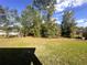Large backyard with mature trees and plenty of space for outdoor activities and relaxation at 15055 Se 93Rd Ct, Summerfield, FL 34491