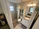 Bathroom featuring a tiled shower, granite countertops, and an attached toilet with storage space at 15055 Se 93Rd Ct, Summerfield, FL 34491