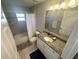 Bathroom featuring tiled floors, granite countertop, a vanity and a tiled shower with a tub at 15055 Se 93Rd Ct, Summerfield, FL 34491