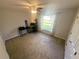 Bedroom features neutral walls, a ceiling fan, and a window offering natural light at 15055 Se 93Rd Ct, Summerfield, FL 34491