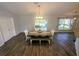 Dining area featuring a wood table, ample seating, and sliding door access to the yard at 15055 Se 93Rd Ct, Summerfield, FL 34491