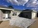 Charming single-story home with a well-maintained exterior and a white rock garden at 15055 Se 93Rd Ct, Summerfield, FL 34491