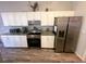 Bright kitchen boasts granite counters, stainless appliances and wood-look vinyl floors at 15055 Se 93Rd Ct, Summerfield, FL 34491