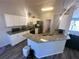 Bright kitchen boasts granite counters, stainless appliances and wood-look vinyl floors at 15055 Se 93Rd Ct, Summerfield, FL 34491