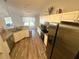 Bright kitchen features granite counters, stainless appliances and wood-look vinyl floors at 15055 Se 93Rd Ct, Summerfield, FL 34491