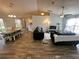 Open-concept living room with wood floors and ample natural light at 15055 Se 93Rd Ct, Summerfield, FL 34491