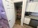 Well-organized pantry next to the kitchen area featuring wood-look floors and wire shelving at 15055 Se 93Rd Ct, Summerfield, FL 34491