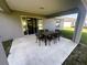 Covered patio with outdoor dining set, perfect for entertaining and relaxation at 15055 Se 93Rd Ct, Summerfield, FL 34491