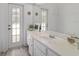 Bathroom featuring a large vanity and double doors to the exterior at 19533 Sw 86Th Ln, Dunnellon, FL 34432