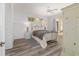 Serene main bedroom with light gray wood flooring and access to outdoor patio through sliding glass doors at 19533 Sw 86Th Ln, Dunnellon, FL 34432