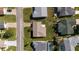 Aerial view of a well-maintained home featuring a brown roof and lush green landscaping at 2013 Cardona Way, The Villages, FL 32159