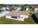 Aerial view of the rear of the house, featuring a patio area and landscaped backyard at 2013 Cardona Way, The Villages, FL 32159