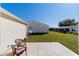 Spacious backyard with a patio, lush green lawn and clear blue sky, offering ample space for outdoor enjoyment at 2013 Cardona Way, The Villages, FL 32159