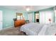 Bedroom featuring light blue walls, ceiling fan, and an ensuite bathroom at 2013 Cardona Way, The Villages, FL 32159