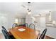 View of a dining area featuring a wood table, seating for six, and access to kitchen at 2013 Cardona Way, The Villages, FL 32159