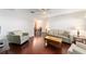 Bright living room featuring hardwood floors, neutral walls, and traditional furnishings at 2013 Cardona Way, The Villages, FL 32159