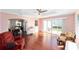 Inviting sun room featuring hardwood floors, a pink walls, and access to dining room and rear patio at 2013 Cardona Way, The Villages, FL 32159