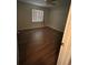 A bright bedroom with wood-look floors is illuminated by a window with coverings at 23 Juniper Pass Ln, Ocala, FL 34480