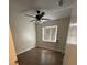 This cozy bedroom features wood-look flooring, a window with blinds, and a modern ceiling fan at 23 Juniper Pass Ln, Ocala, FL 34480