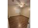 Inviting bedroom with wood-look flooring, a window with blinds, and a ceiling fan at 23 Juniper Pass Ln, Ocala, FL 34480