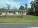 Well-maintained single-story house with a mature landscaped front yard at 23 Juniper Pass Ln, Ocala, FL 34480