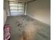 Spacious garage with high ceilings and a roll-up door at 23 Juniper Pass Ln, Ocala, FL 34480