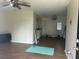 Open-concept living room featuring wood-look floors and a ceiling fan at 23 Juniper Pass Ln, Ocala, FL 34480