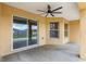 Covered back porch with ceiling fan offering plenty of space for relaxing and entertaining outdoors at 234 Locust Pass Loop, Ocala, FL 34472
