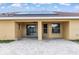 Covered back porch with ceiling fan offering plenty of space for relaxing and entertaining outdoors at 234 Locust Pass Loop, Ocala, FL 34472