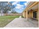 Covered back porch with ceiling fan offering plenty of space for relaxing and entertaining outdoors at 234 Locust Pass Loop, Ocala, FL 34472