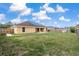 A spacious backyard featuring a well-maintained lawn and a wood fence offering privacy at 234 Locust Pass Loop, Ocala, FL 34472