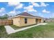 The backyard has a well-maintained lawn, privacy fence, and sidewalk leading to a gate at 234 Locust Pass Loop, Ocala, FL 34472
