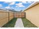Close-up view of the backyard fence and walkway; the yard is well maintained at 234 Locust Pass Loop, Ocala, FL 34472
