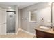 Bright bathroom with marble shower, vanity, granite countertop, and tile floors at 234 Locust Pass Loop, Ocala, FL 34472