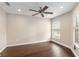 Bright bedroom with wood flooring, a ceiling fan, and a sunny window, creating a comfortable space at 234 Locust Pass Loop, Ocala, FL 34472