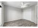 Bedroom with gray flooring, ceiling fan, closet and light gray painted walls at 234 Locust Pass Loop, Ocala, FL 34472