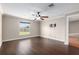 Bedroom featuring hardwood floors, a ceiling fan and a window with natural light at 234 Locust Pass Loop, Ocala, FL 34472