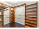 Organized closet features stained wood shelving and dark wood floors at 234 Locust Pass Loop, Ocala, FL 34472