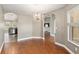 Bright dining area featuring hardwood floors, chandelier, and views into the kitchen and living room at 234 Locust Pass Loop, Ocala, FL 34472