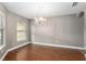 Formal dining room featuring hardwood floors, neutral paint, a chandelier, and ample natural light at 234 Locust Pass Loop, Ocala, FL 34472