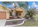 Close up of a single Gathering home featuring the entrance and manicured landscaping at 234 Locust Pass Loop, Ocala, FL 34472