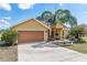 Close up of a single Gathering home featuring the entrance and manicured landscaping at 234 Locust Pass Loop, Ocala, FL 34472