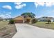 Charming home featuring a long driveway, lush front lawn, and mature landscaping at 234 Locust Pass Loop, Ocala, FL 34472