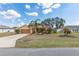 Inviting single Gathering home with a long driveway and beautiful landscaping at 234 Locust Pass Loop, Ocala, FL 34472