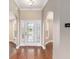 Elegant foyer features hardwood flooring and a decorative glass front door with sidelights and transom window at 234 Locust Pass Loop, Ocala, FL 34472