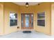 Detailed view of the front door featuring decorative glass and sidelights, plus a classic overhead light fixture at 234 Locust Pass Loop, Ocala, FL 34472