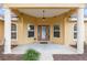 Close-up of the front entrance, highlighting the decorative glass front door and covered porch with columns at 234 Locust Pass Loop, Ocala, FL 34472