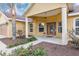 Inviting front exterior of home, showcasing a covered porch, well-maintained landscaping, and decorative lighting at 234 Locust Pass Loop, Ocala, FL 34472