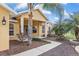 Charming single-story home featuring lush landscaping and a welcoming front porch with stately columns at 234 Locust Pass Loop, Ocala, FL 34472