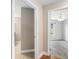 Bright hallway view, leading to a bedroom with hardwood floors and a ceiling fan at 234 Locust Pass Loop, Ocala, FL 34472